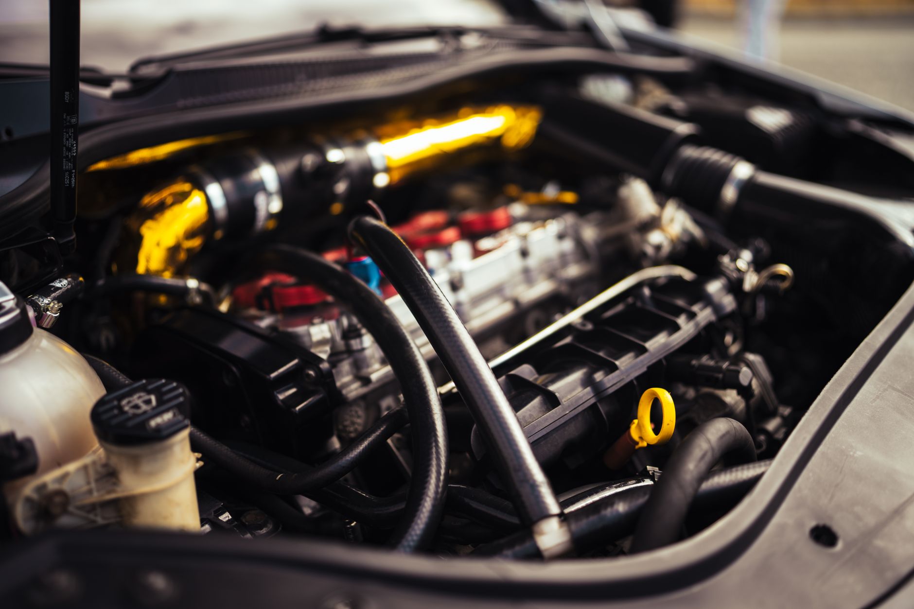 Independent specialist mechanic working on a performance car engine bay, illustrating the independent specialist vs main dealer performance car UK debate