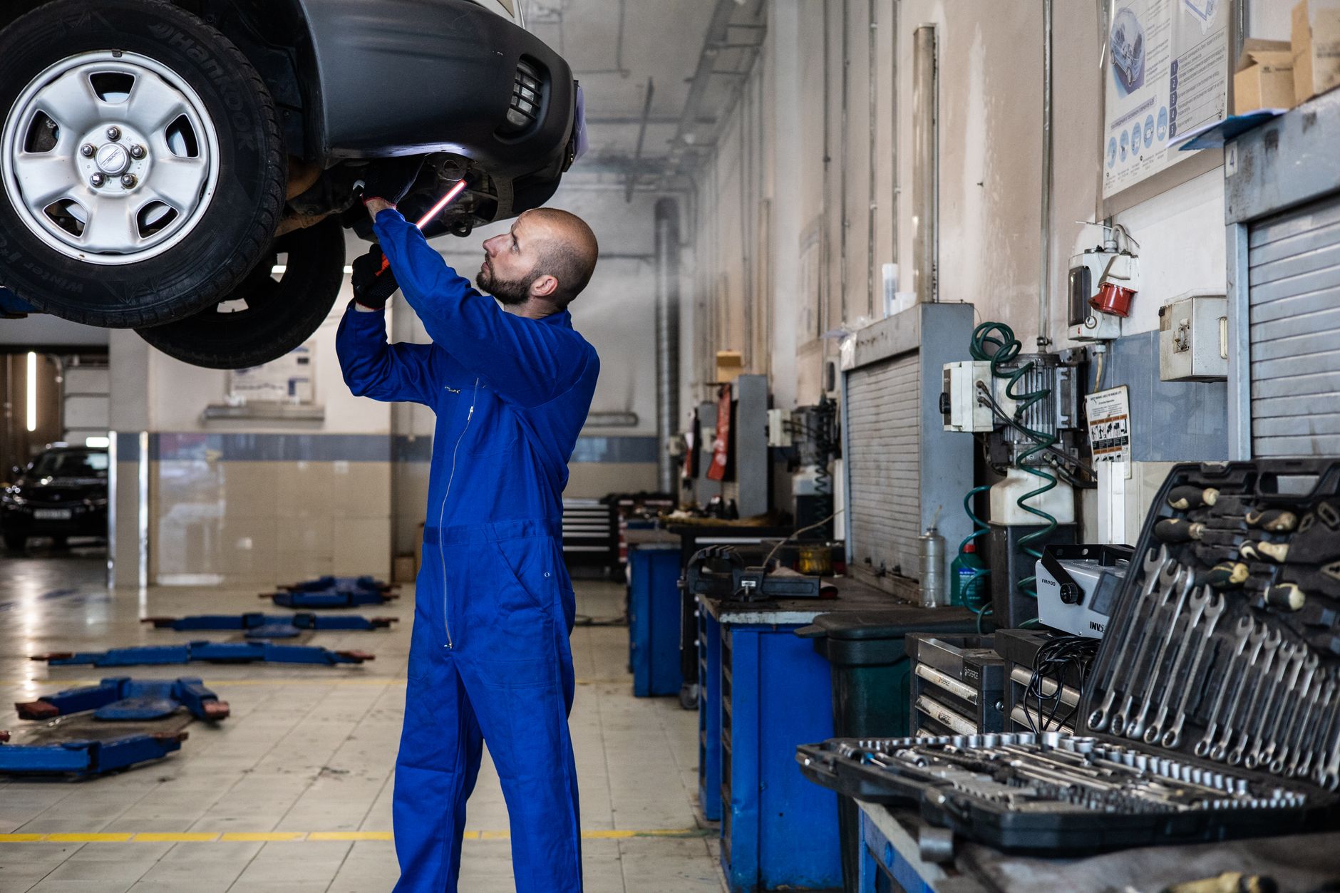 Mechanic inspecting modified car on lift during MOT test — modified car MOT failure UK 2026