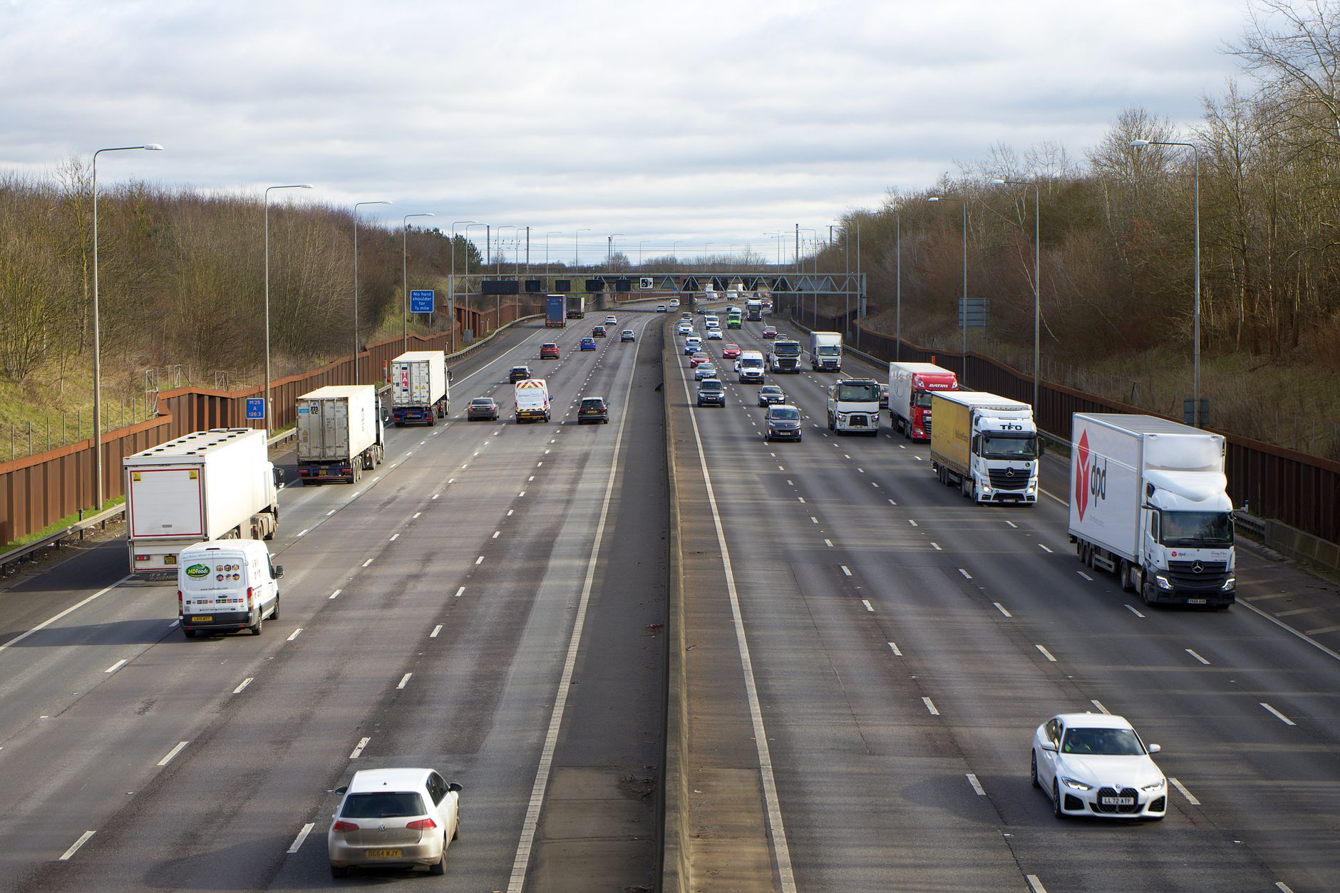Overhead speed camera on smart motorway gantry enforcing variable speed limits